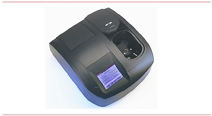 A photograph shows an overhead diagonal view of a spectrophotometer. A small square digital display screen appears to the left of an oval opening containing circular sample holders for test tubes.